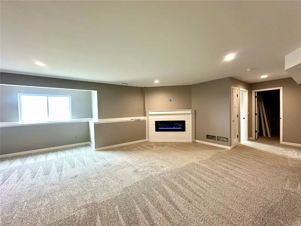 Lower Level Rec Room with Electric Fireplace. If a buyer wants to have the lower level finished by the builder - Cost $31,000. Currently Unfinished.