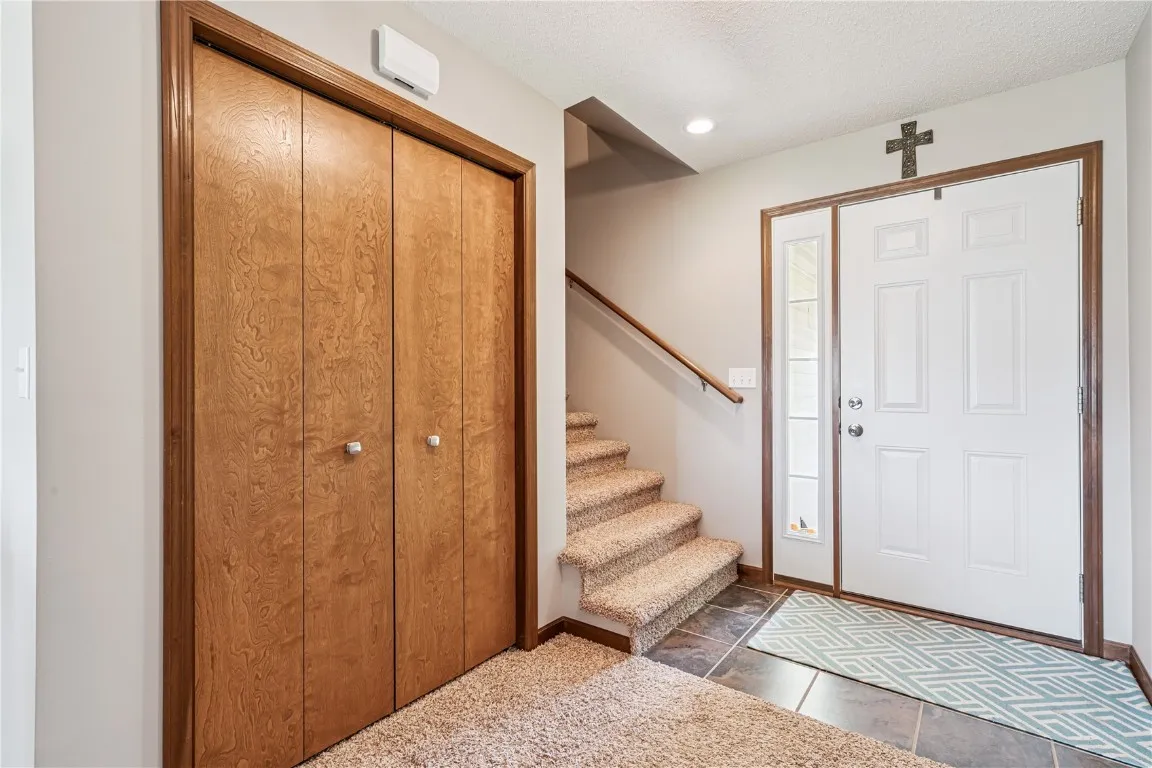 Interior view of front door and entry with closet.