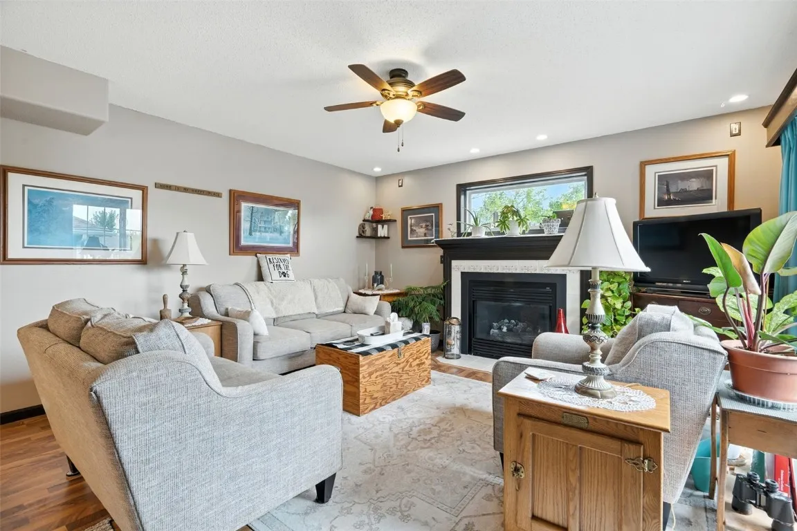 Living room is fresh and airy with all of its great windows and then the fireplace is a big bonus... Just serviced last year
