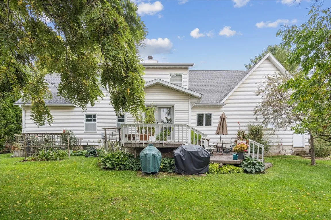 Backyard with entrance to sunroom and stairs to yard from 2 level deck