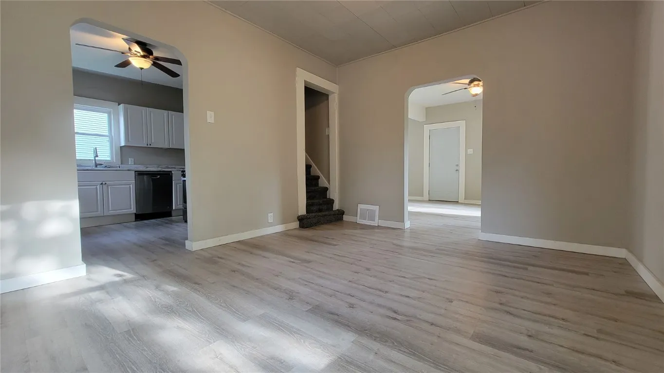 Dining Room View to Kitchen, Stairway to 2nd Floor and Entry Door in Living Room