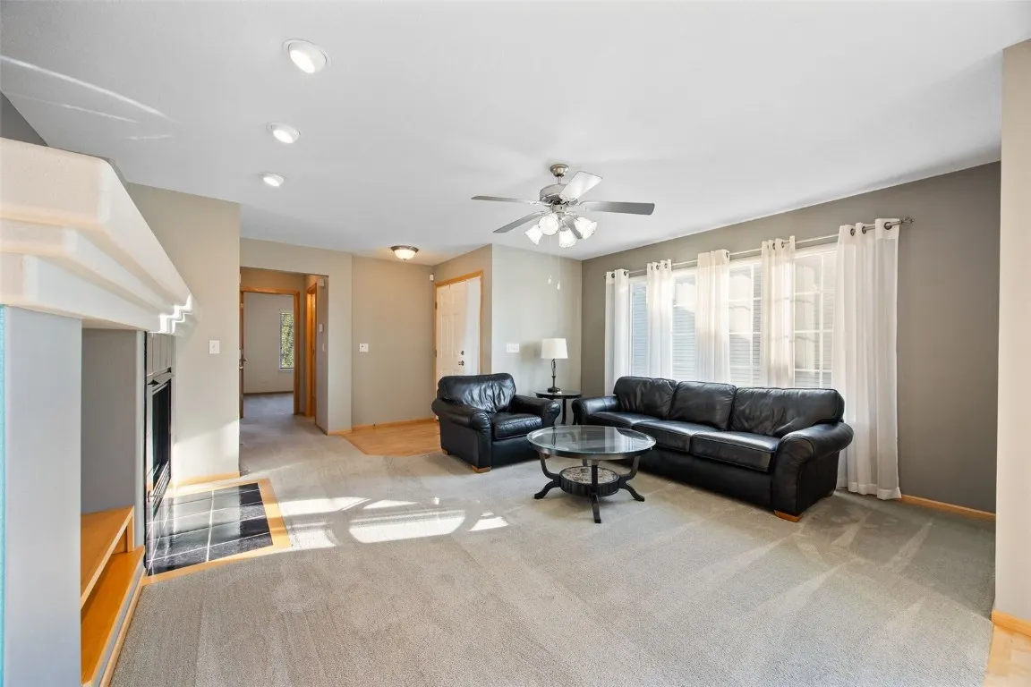 Living room with gas fireplace.  Gobs of natural light! Furniture shown is available for purchase.