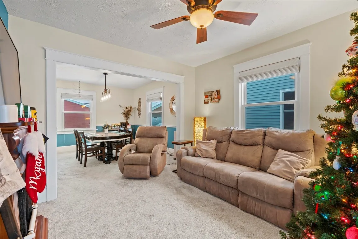Living room facing dining room towards back of home