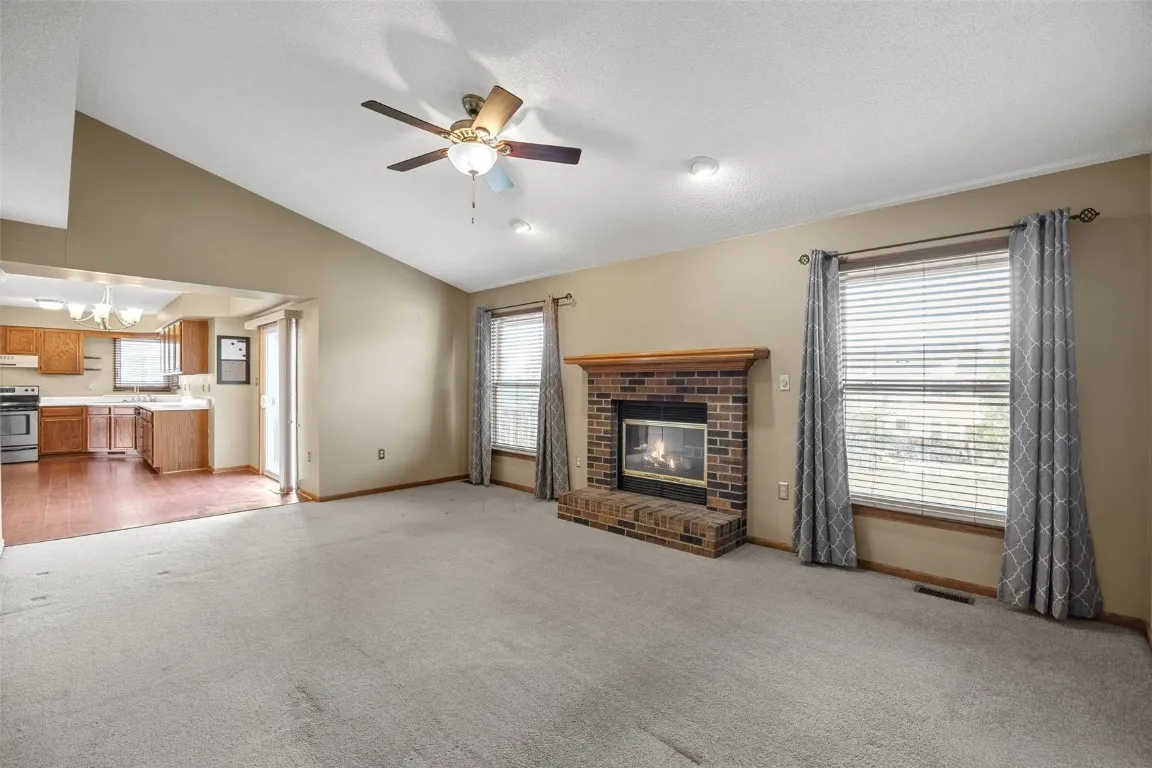 Family room has wood burning fireplace and a valuted ceiling.