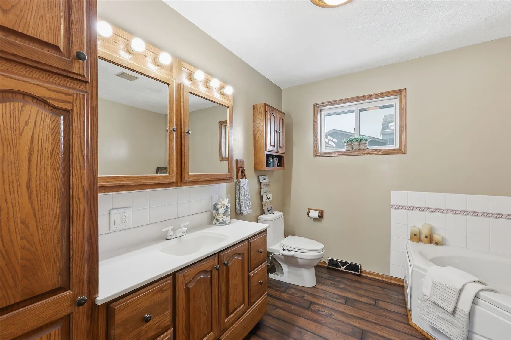 Primary bathroom with jetted tub, shower, bidet and linen closet.