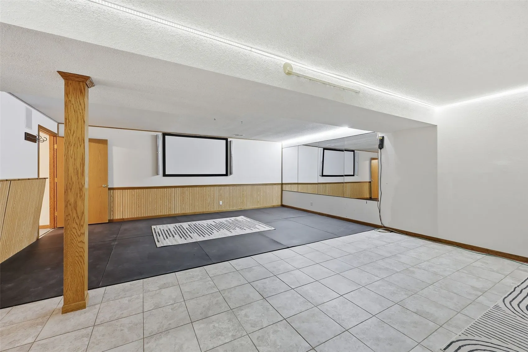 LL rec room perfect for a workout space, a pool table or other fun activities. It's also set up for a projector.