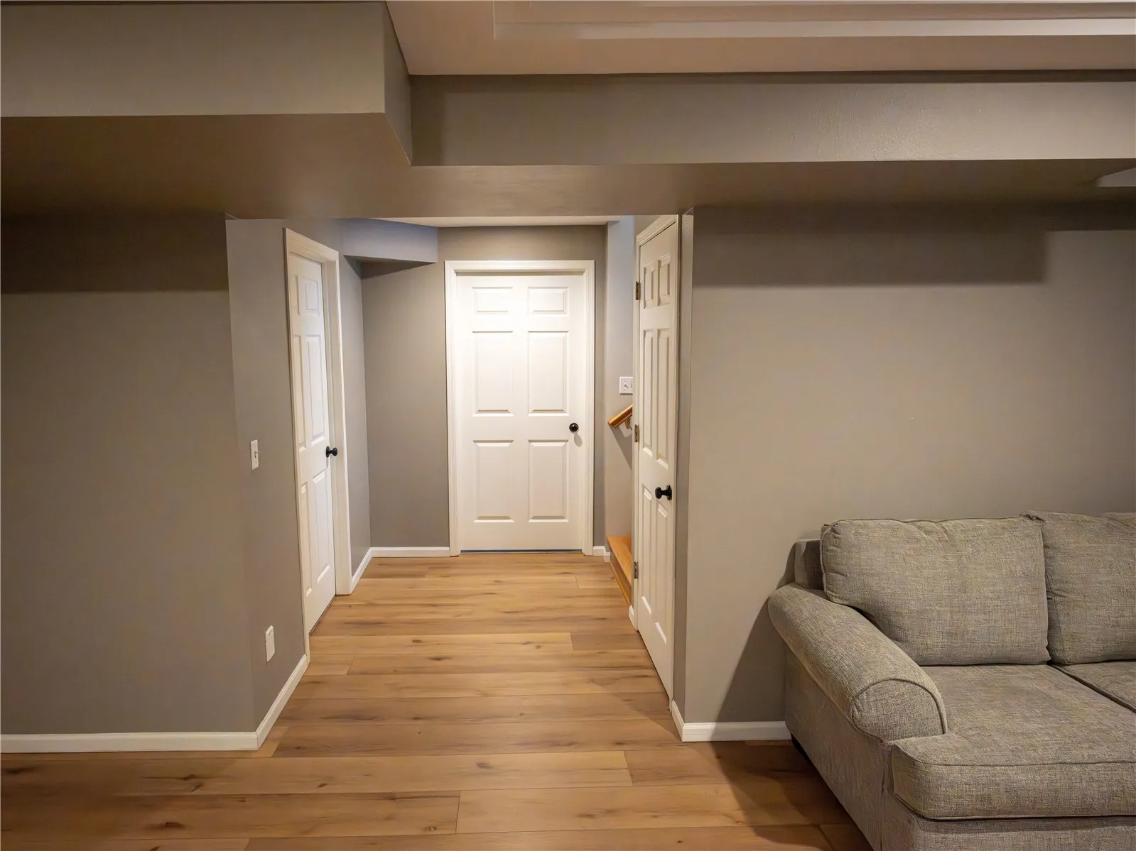 Basement Landing, storage straight ahead, utilities in the door to the left and under stair storage to the right