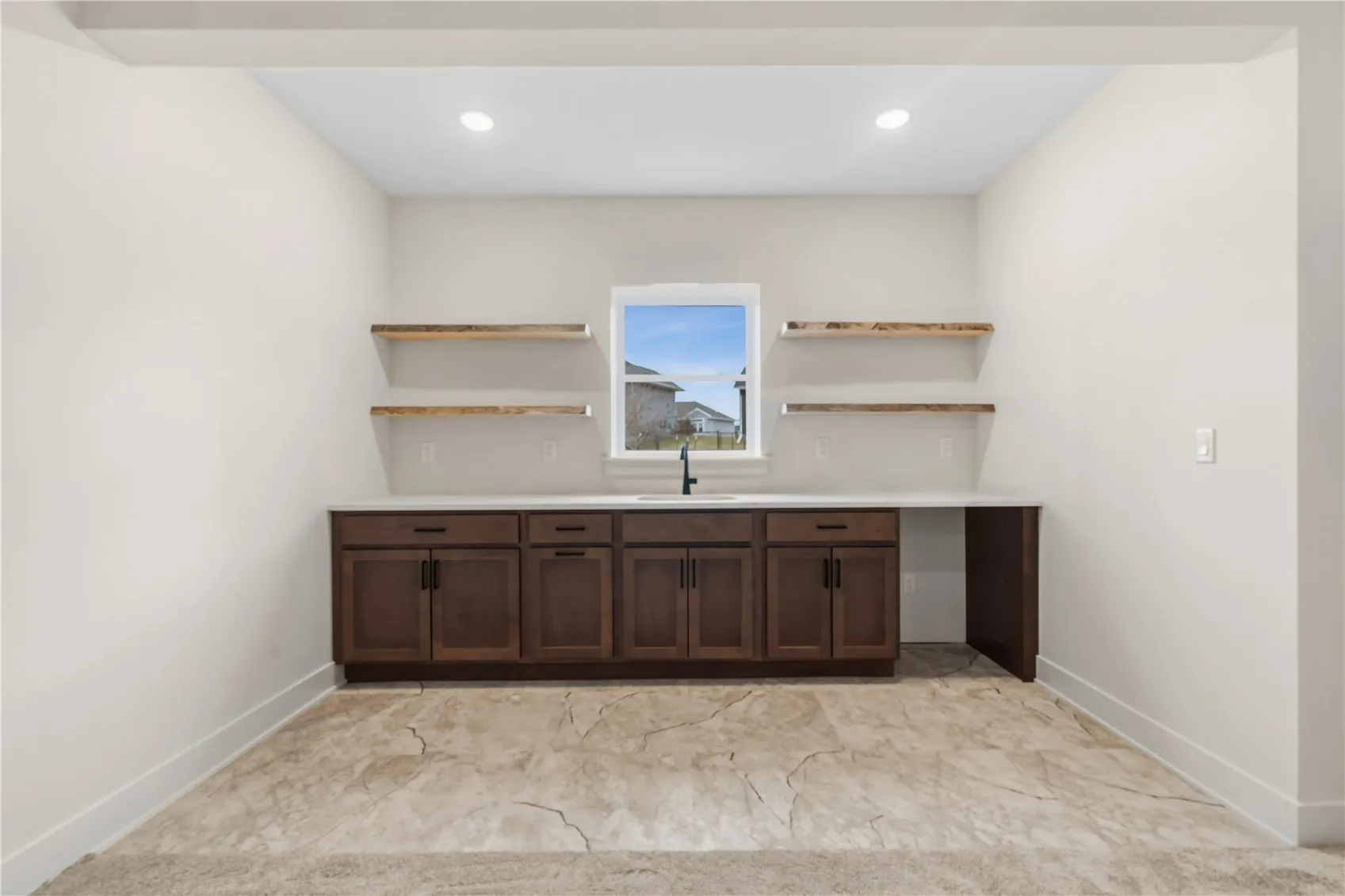 Lower level wet-bar with wood shelving.
