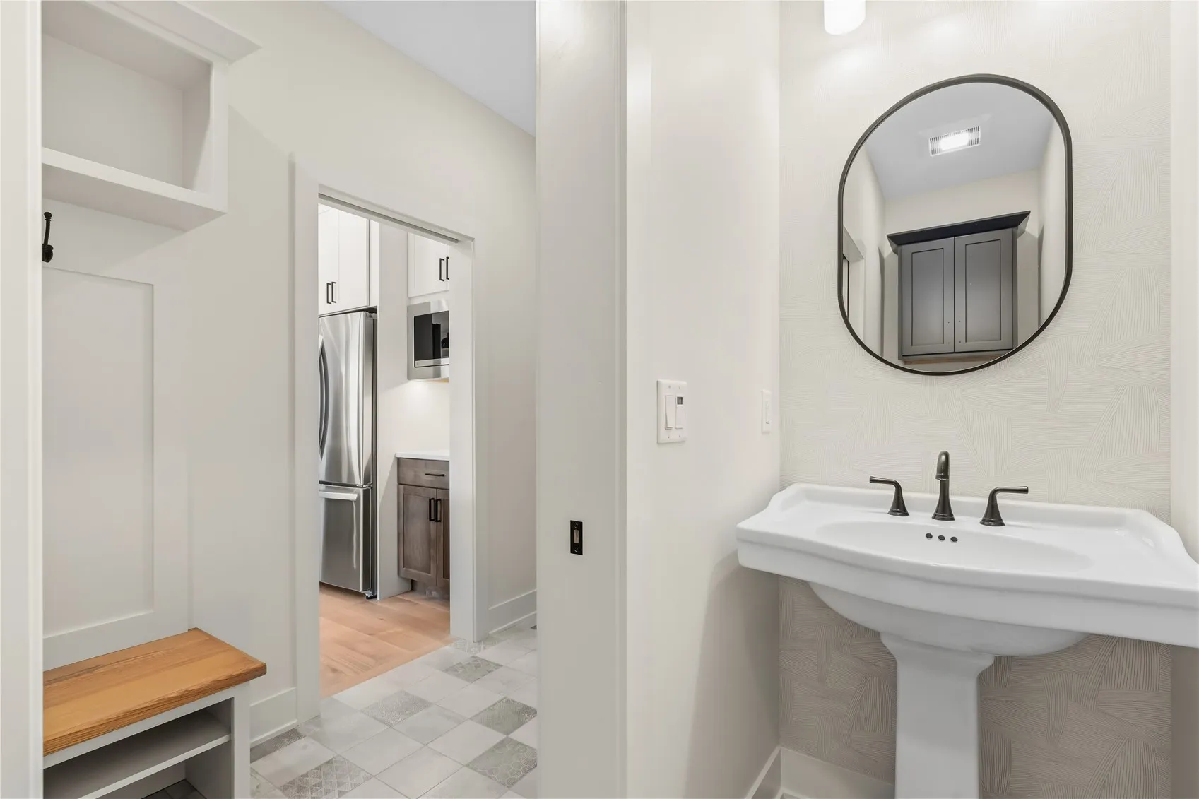 Half-bath located just beyond garage entry.