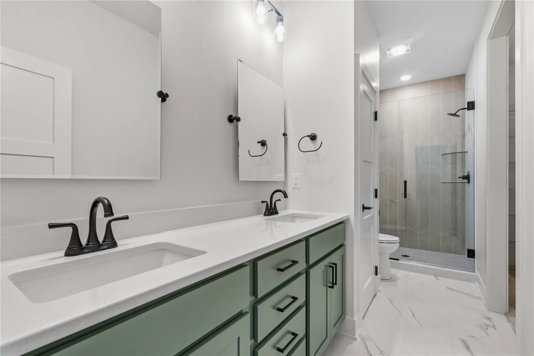 Primary bedroom bathroom with dual vanity.