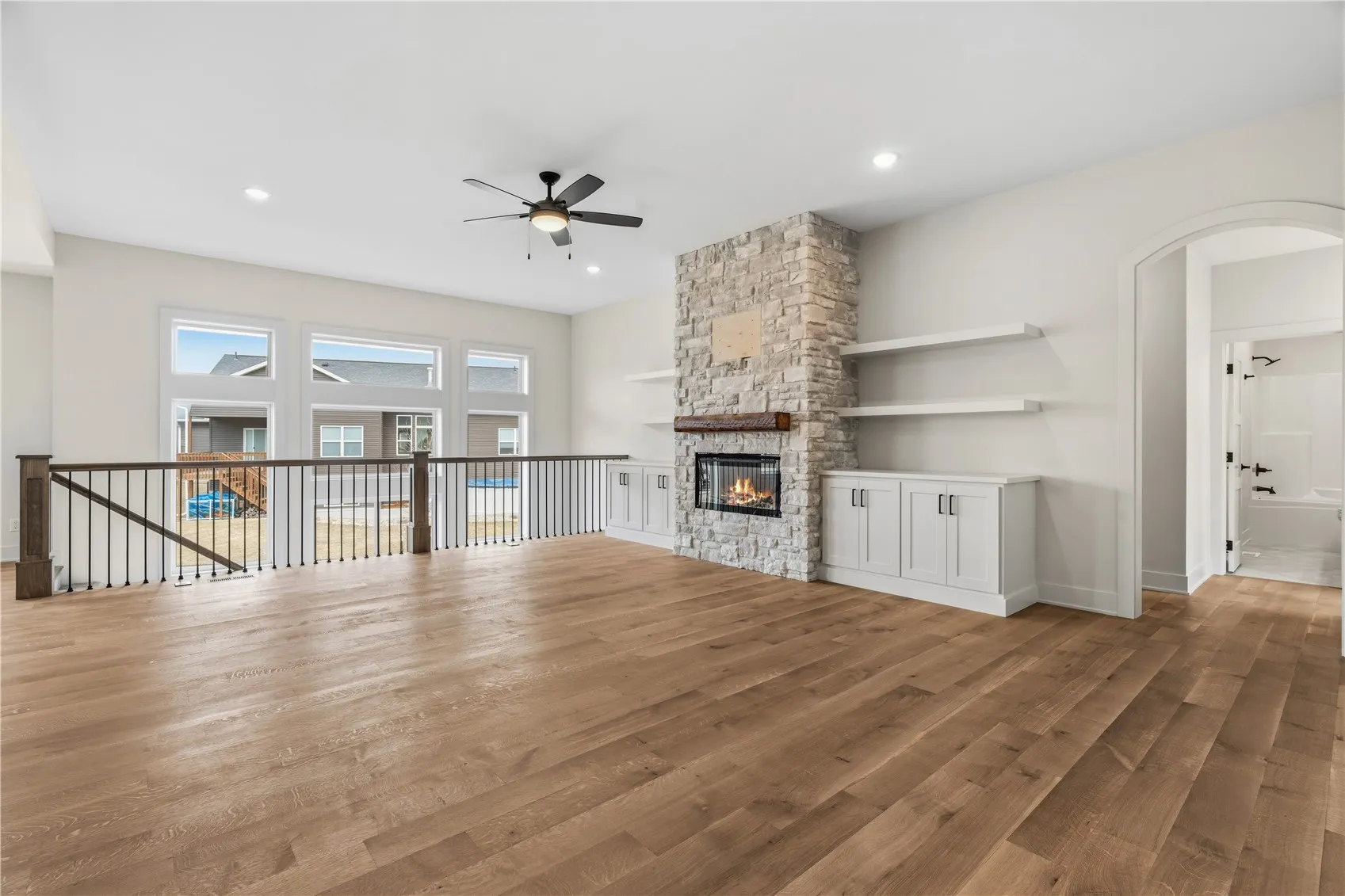 Custom stone fireplace with built in shelving & storage.