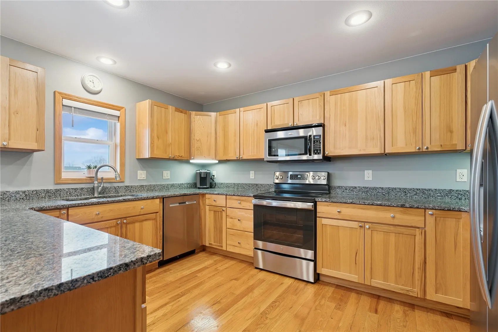 Kitchen area with Hickory cabinets and stainless steel appliances