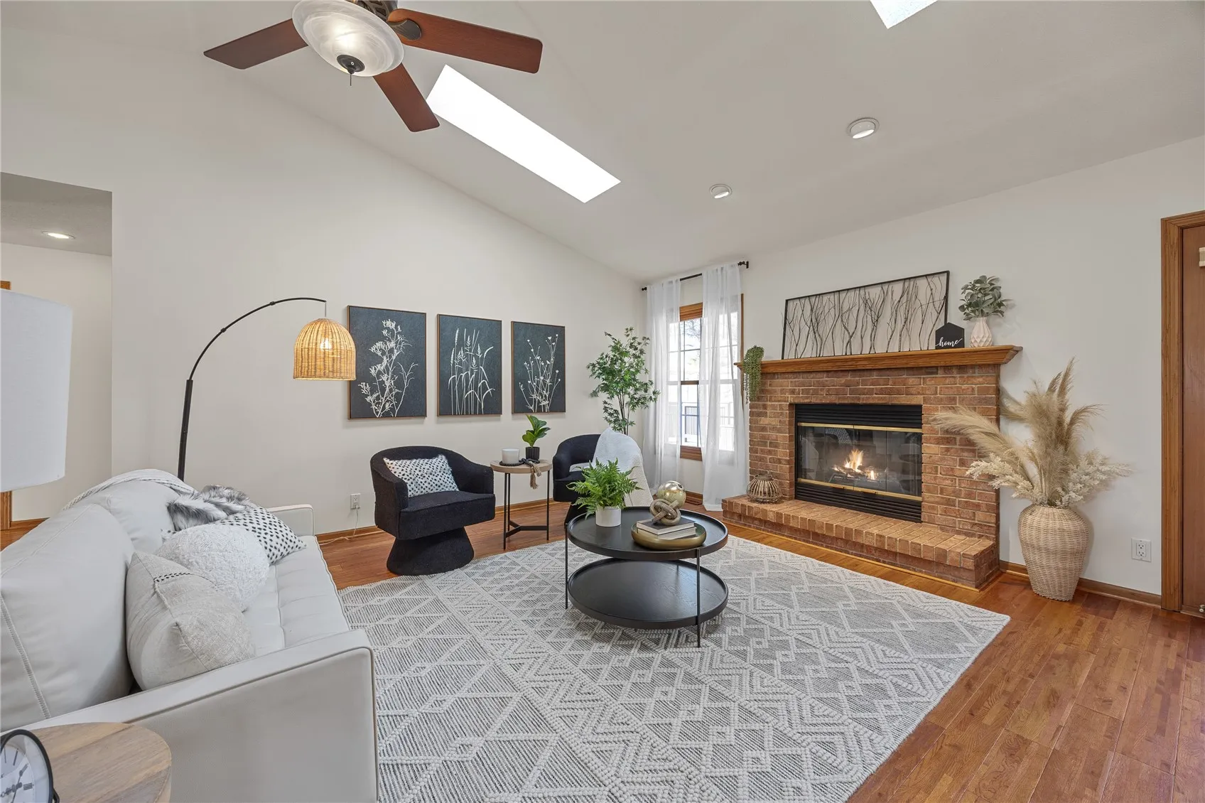 Living room with gas fireplace. Has an insert of gas, so it can be used as a wood burning fireplace or with a artificial log fireplace insert, or it can be enclosed by a professional as a gas fireplace 