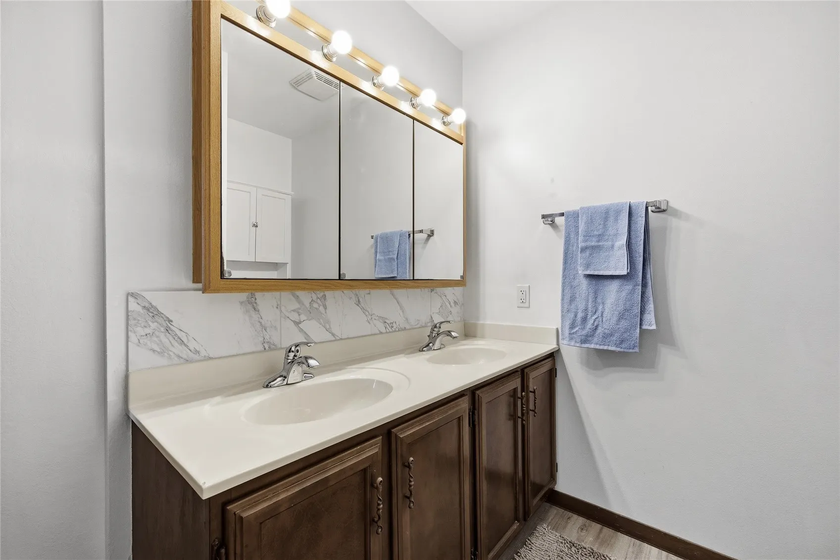 Updated bath off hallway with double sinks.