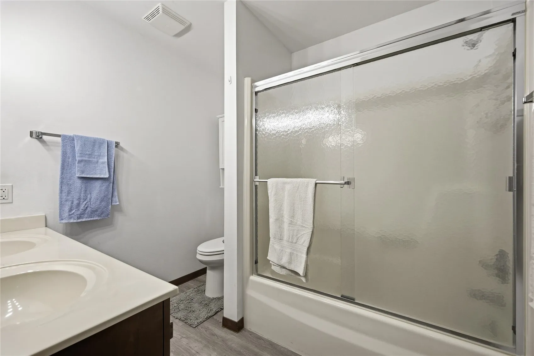 Bathroom with high stool , new flooring and updated lights.