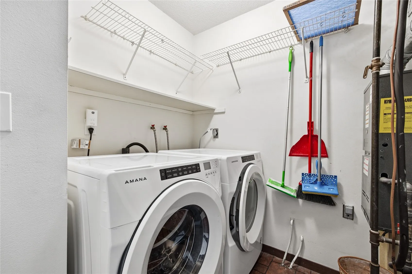 Utility room with Amana washer and dryer.