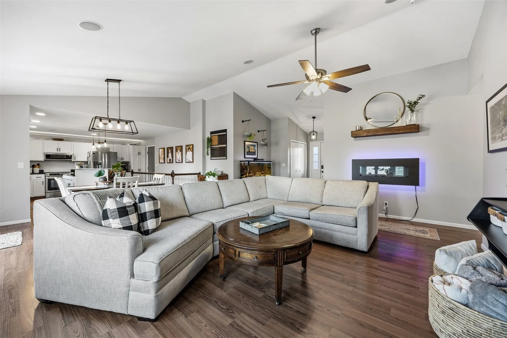 Living room with view of front door and kitchen