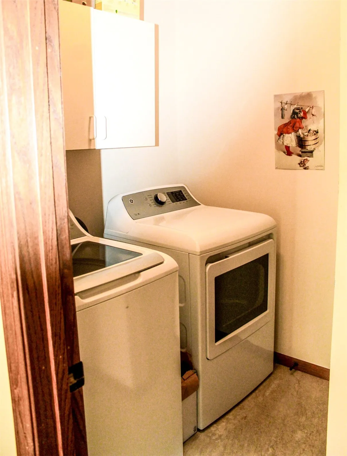 Laundry area off kitchen with nice storage.