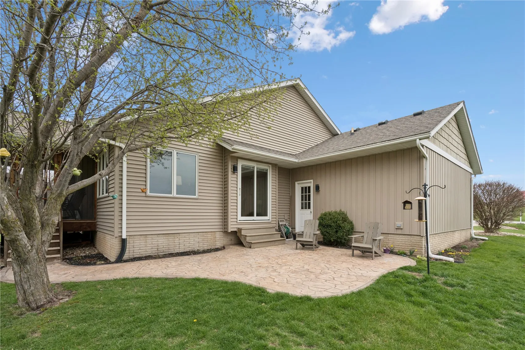 Enter into the casual dining area of the home from the stamped patio or use the sidewalk to the screened porch