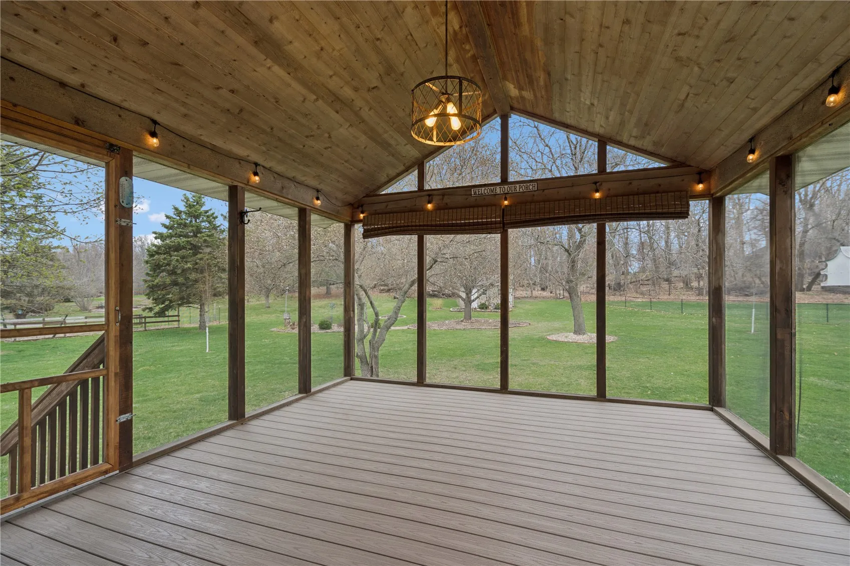 Vaulted screened porch looks to the wooded area behind the home