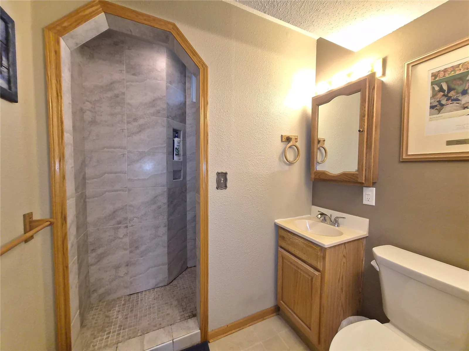 Lower level full bath with tile shower.