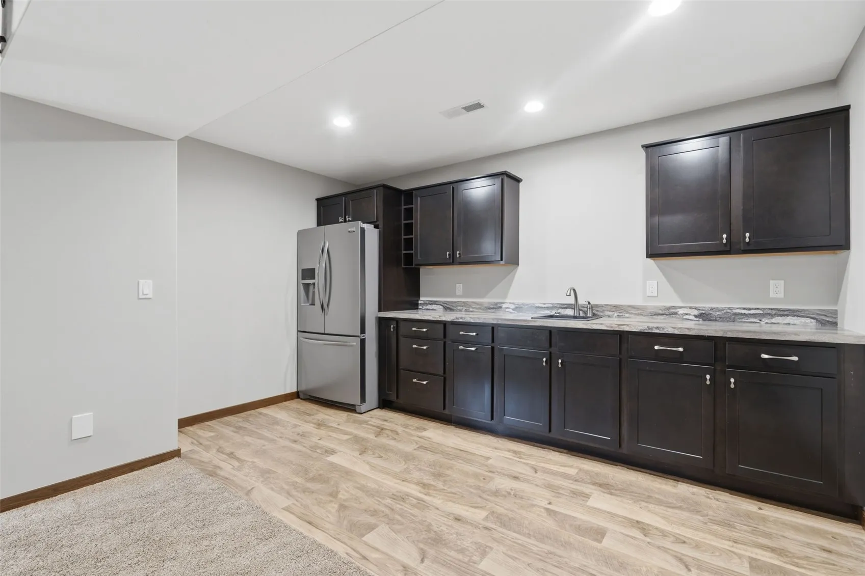 Wet bar with fridge, basement