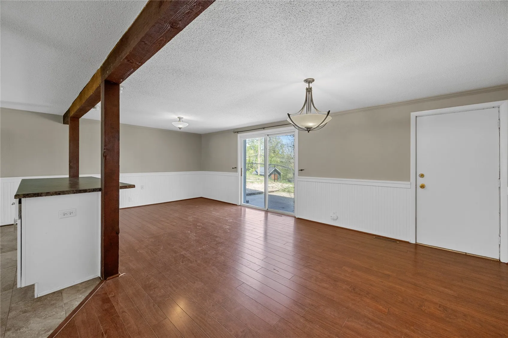 Large dining room area with breakfast island. The walkout goes to a large cement patio.