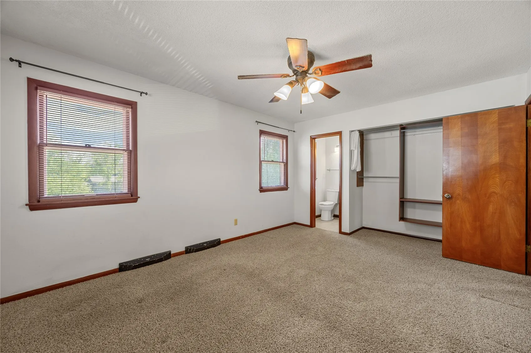 View of the primary bedroom which has a 1/2 bath.