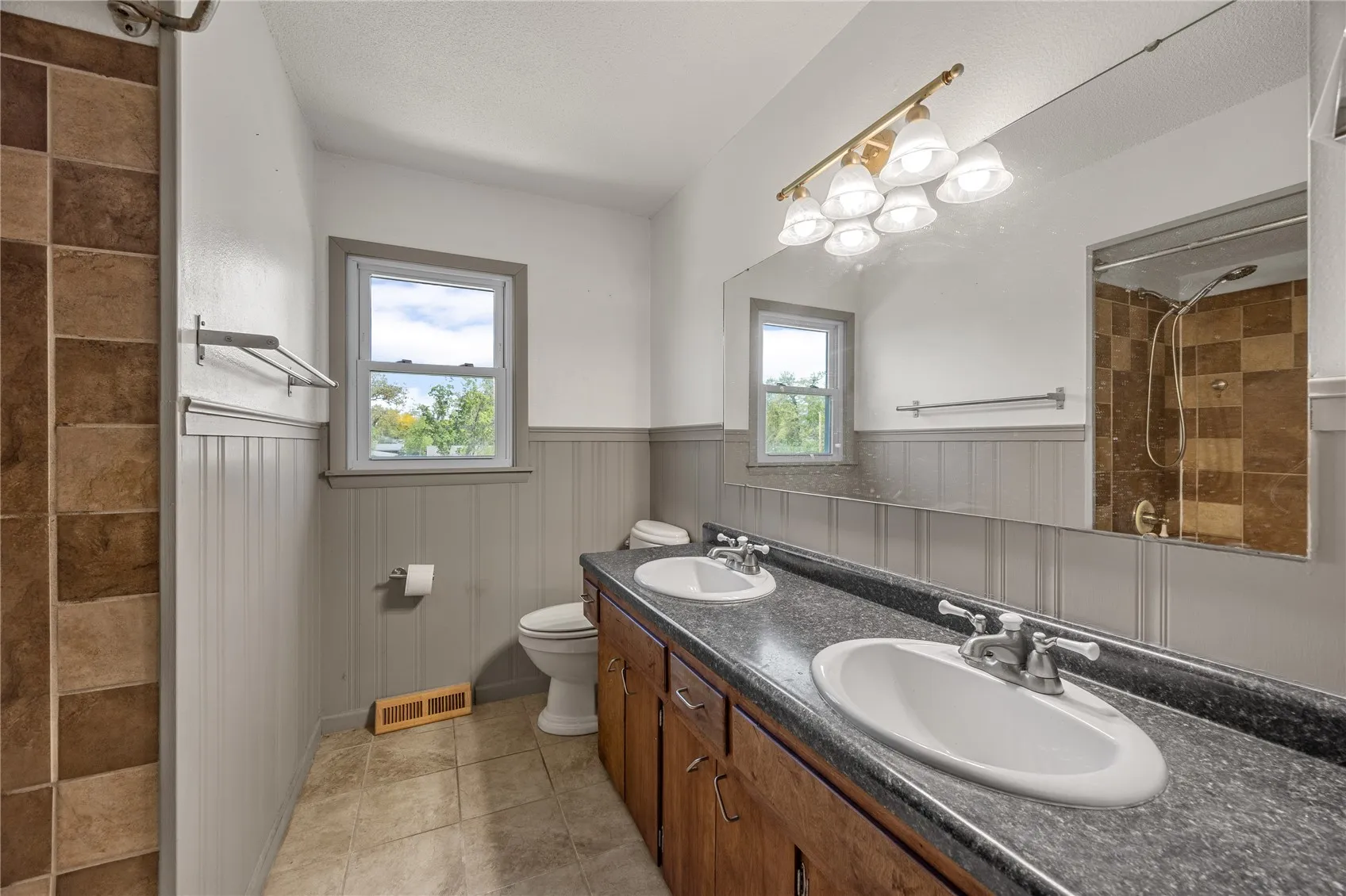 Full bath with two basins located on the second level.