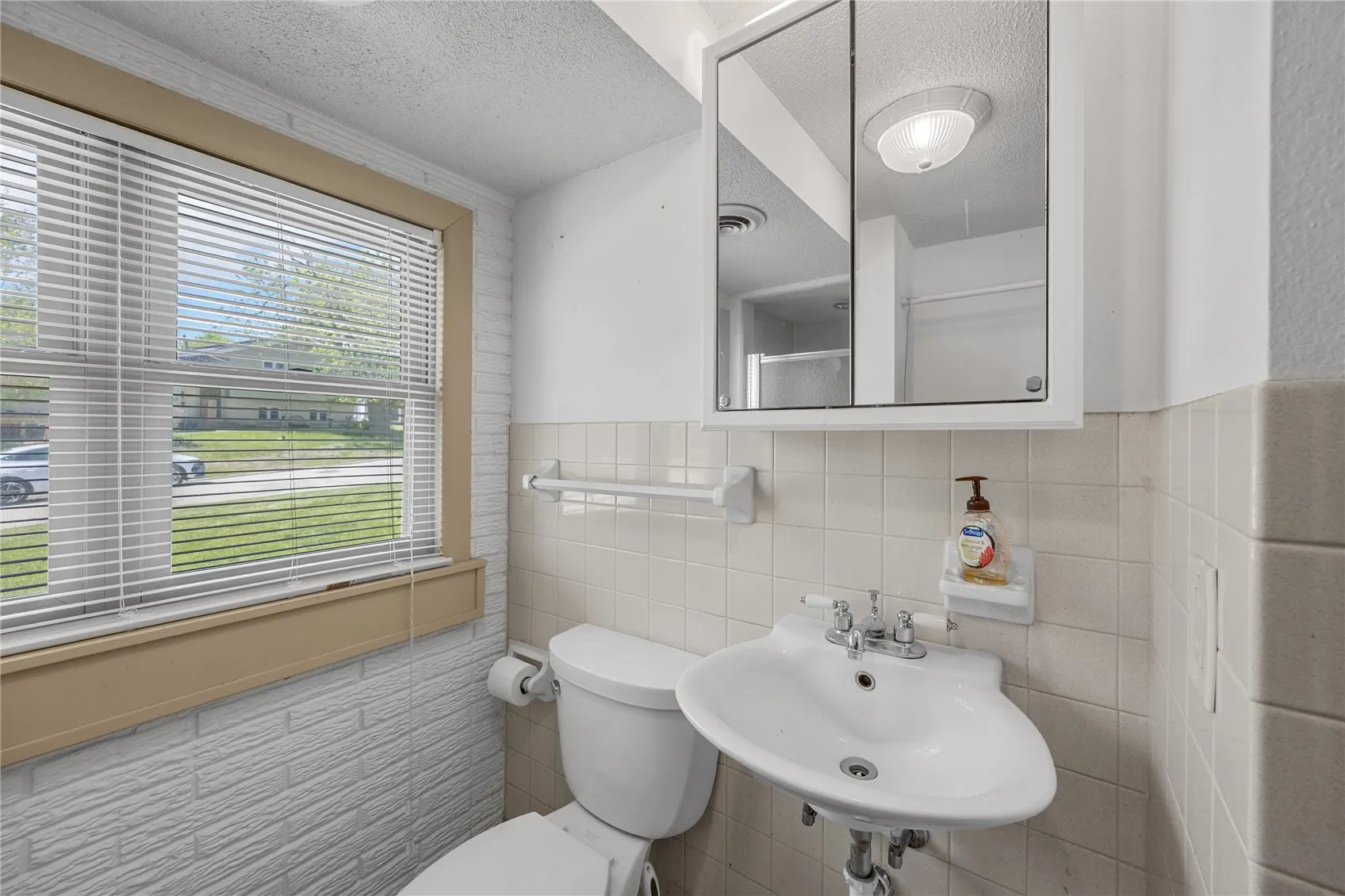 Located to the left as one goes down the steps is the laundery room and a full bath with shower.