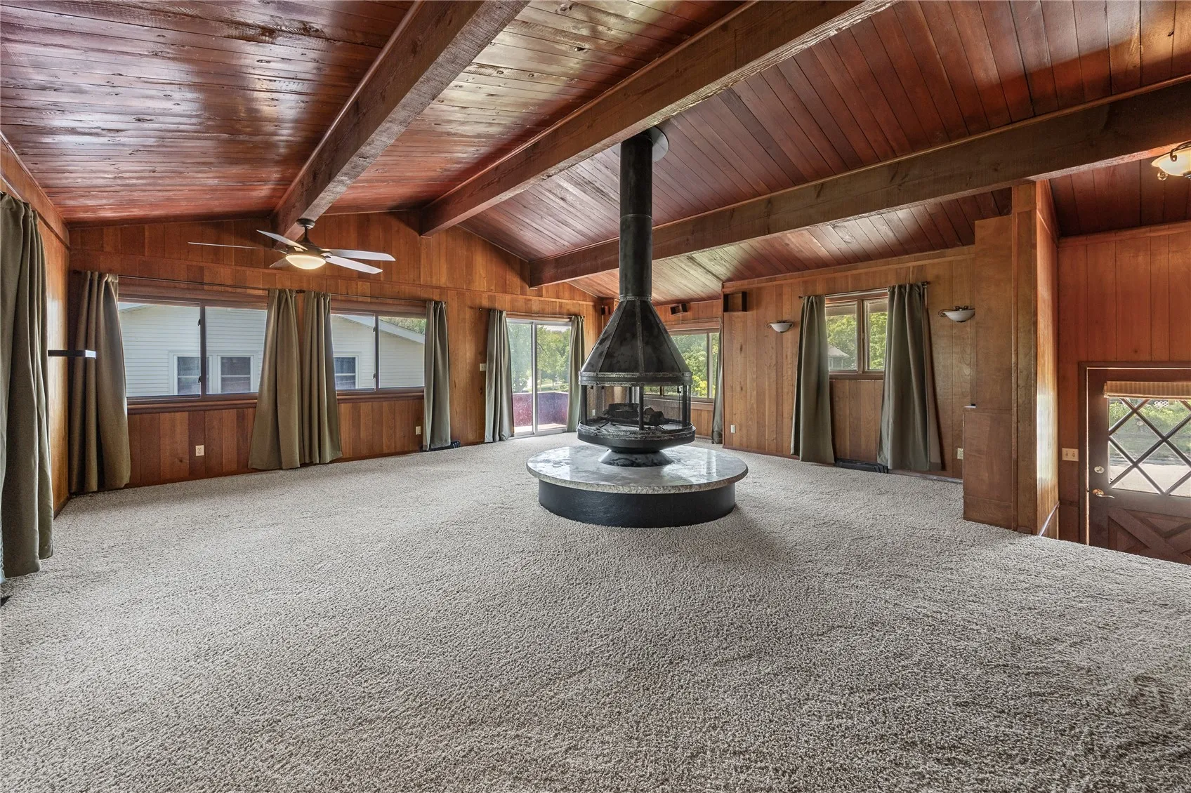 Great room with gas fireplace looking to the southwest. Yes, two exits to the wrap around deck. The entrance door is on the right.