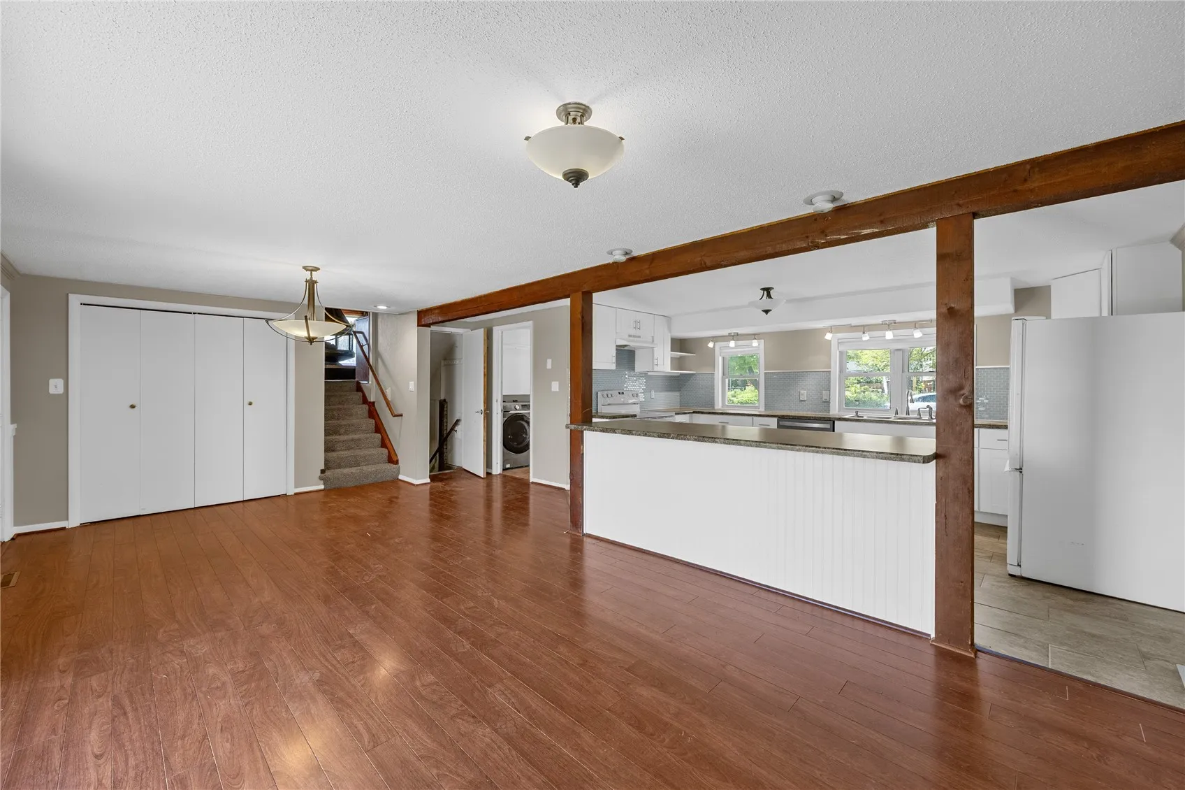 Large dining room area with breakfast island which separates the kitchen from the dining room.