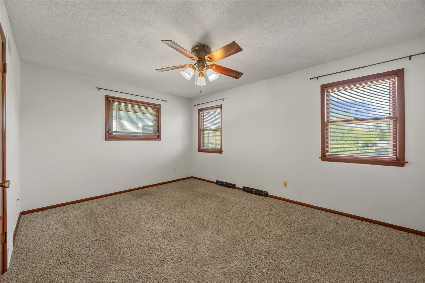 View of the primary bedroom which has a 1/2 bath.