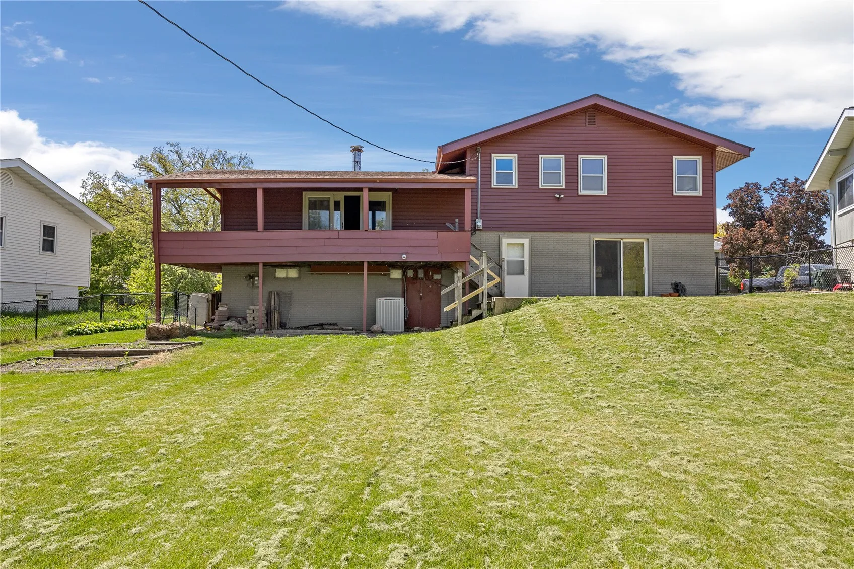 Located to the left in the picture are two planting beds and a compost area. You can see the small storage shed located to the left under the deck on the side of the house. The decorative blocks and rocks stay with the buyer.