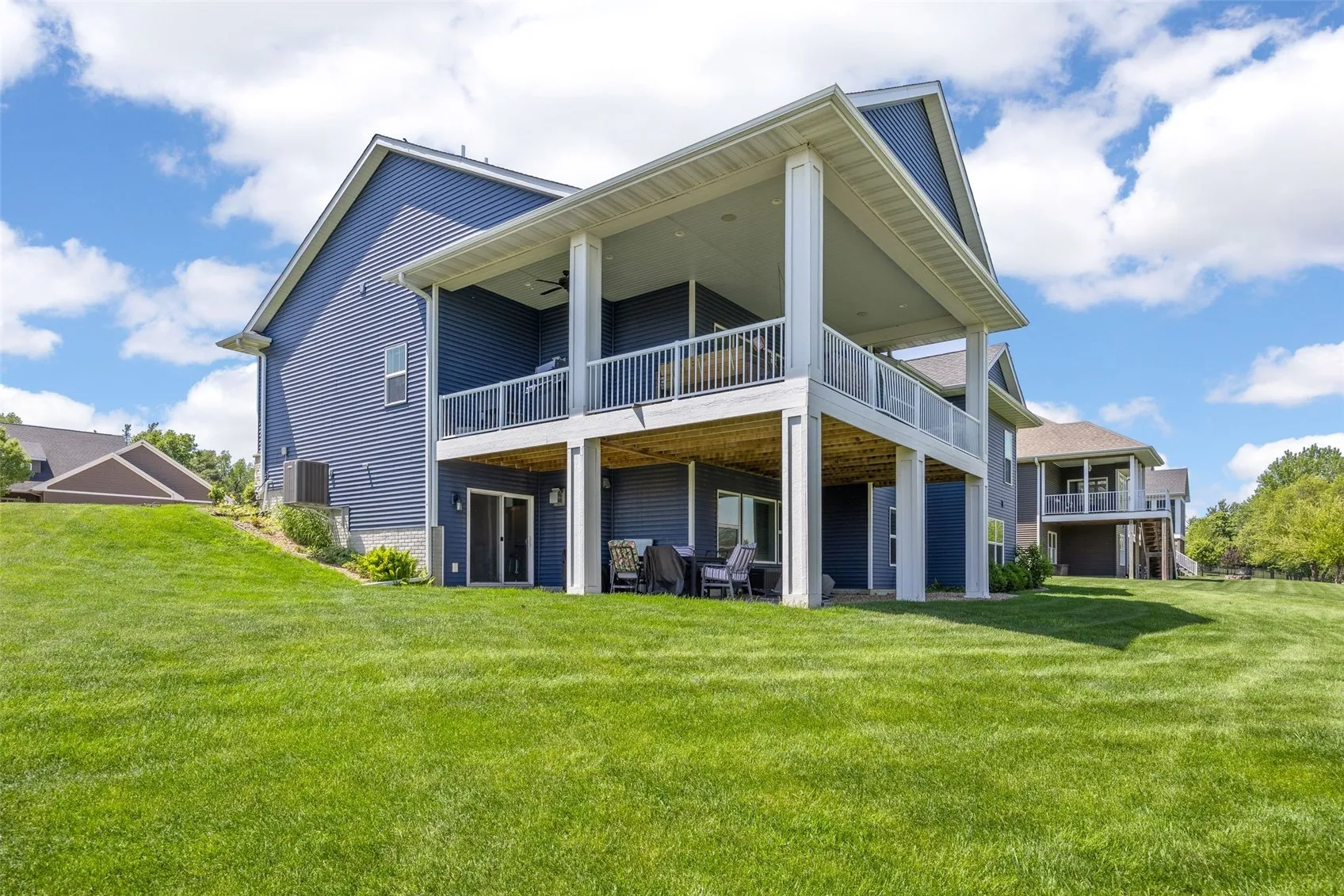 The pation below the deck provides added space for relaxation and enjoyment of the expansive lawn.