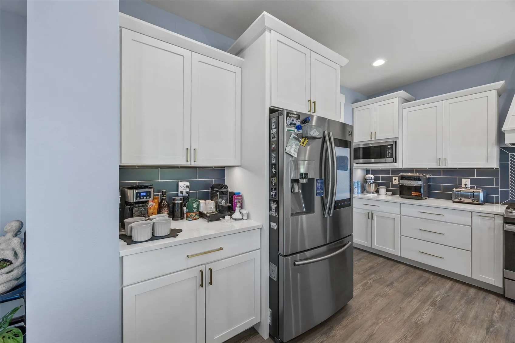 Custom cabinets and side by side refrigerator which stays with property.