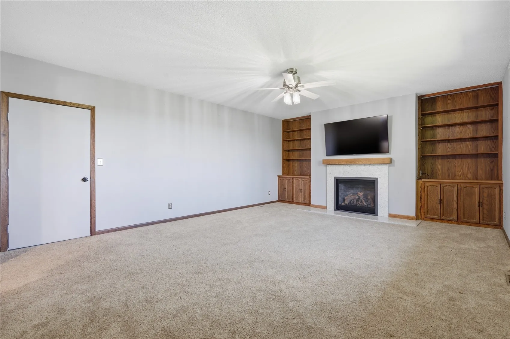 family room with new (2021) gas fireplace and wall-mounted tv