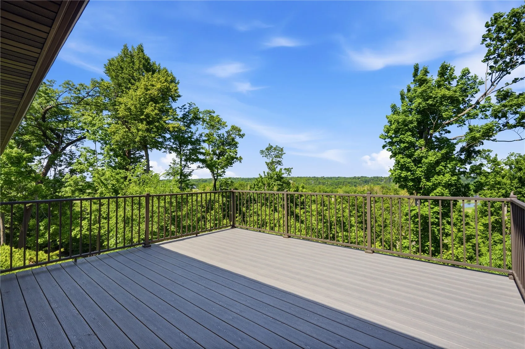 deck with views of golf course and nature