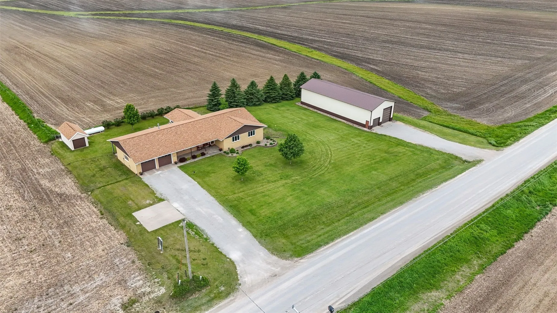Front view of 1.24 acres! 30x80 sf. pole building and large shed.