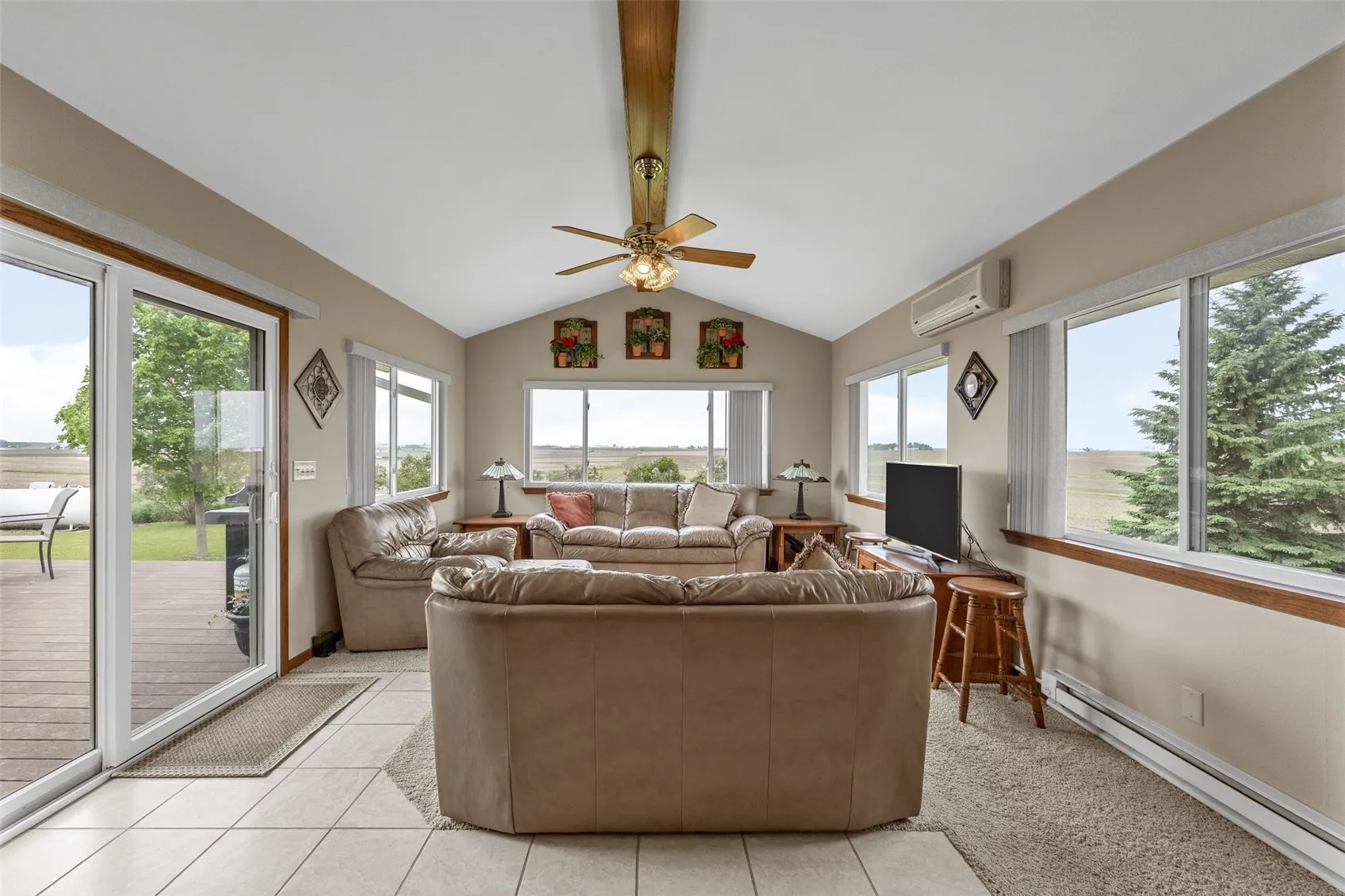 A vaulted ceiling awaits in the four season's addition.  The room has plenty of windows with access to the large deck through a sliding glass door.