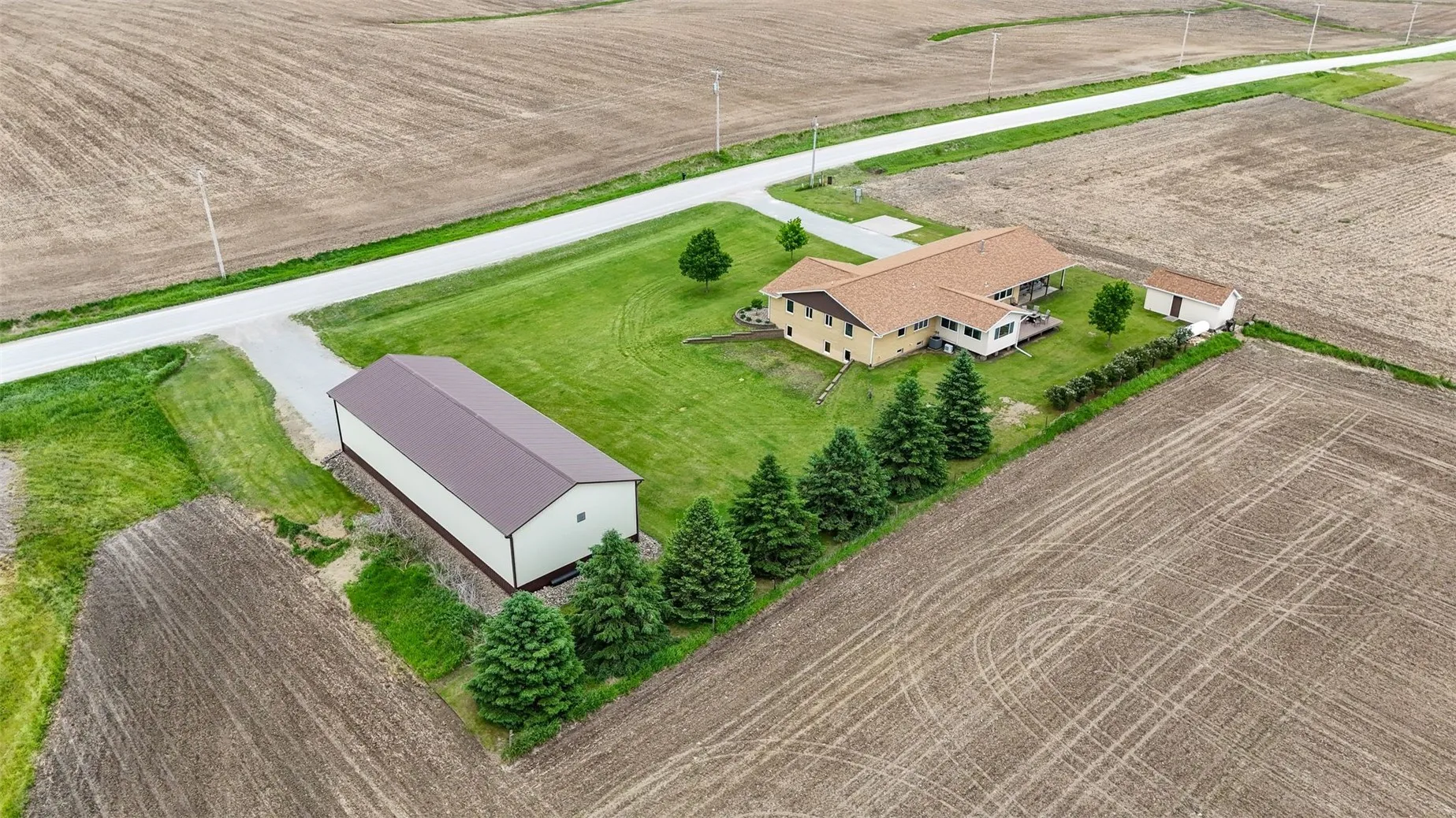 Back view of 1.24 acres! 30x80 sf. pole building and large shed.