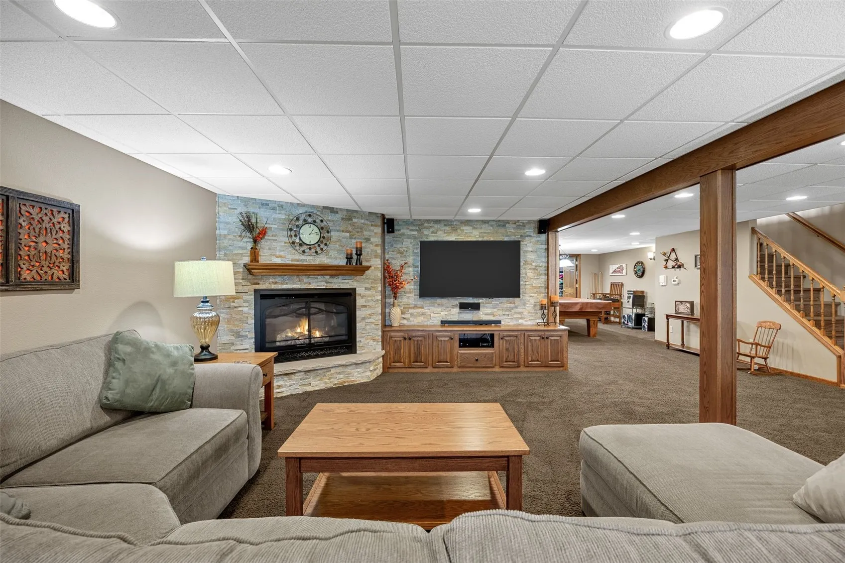 Lower level with a a gas fireplace that works with the thermostat.