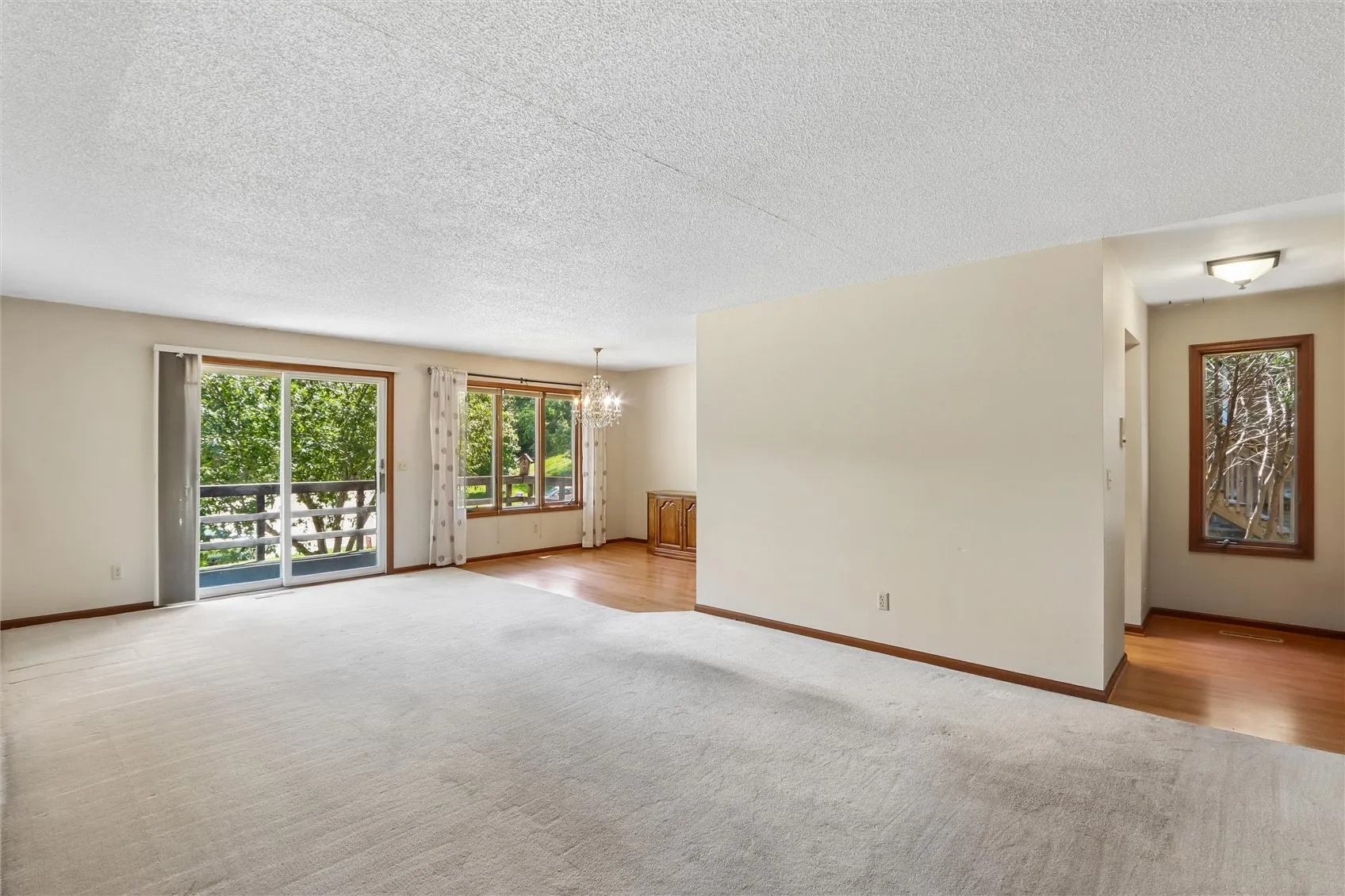 Large living room with slider to covered deck.