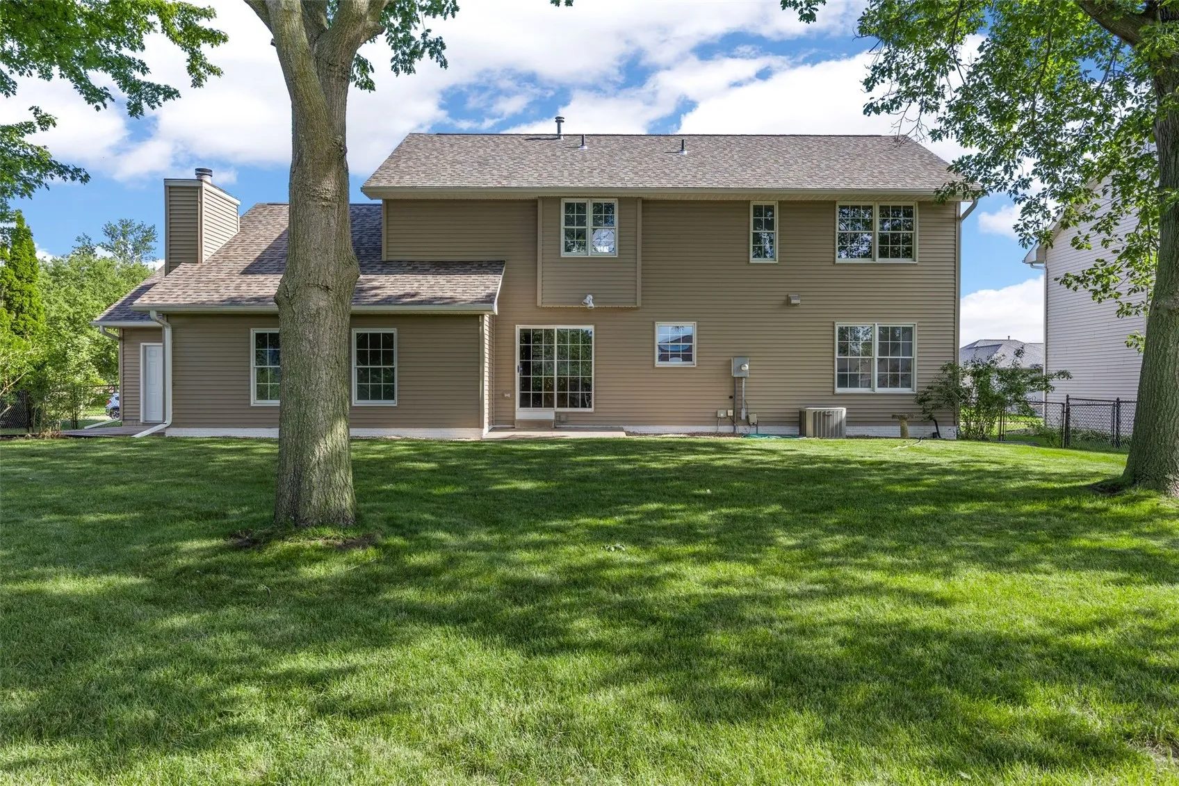 Fenced In Backyard with Swing Set and Garden Plots