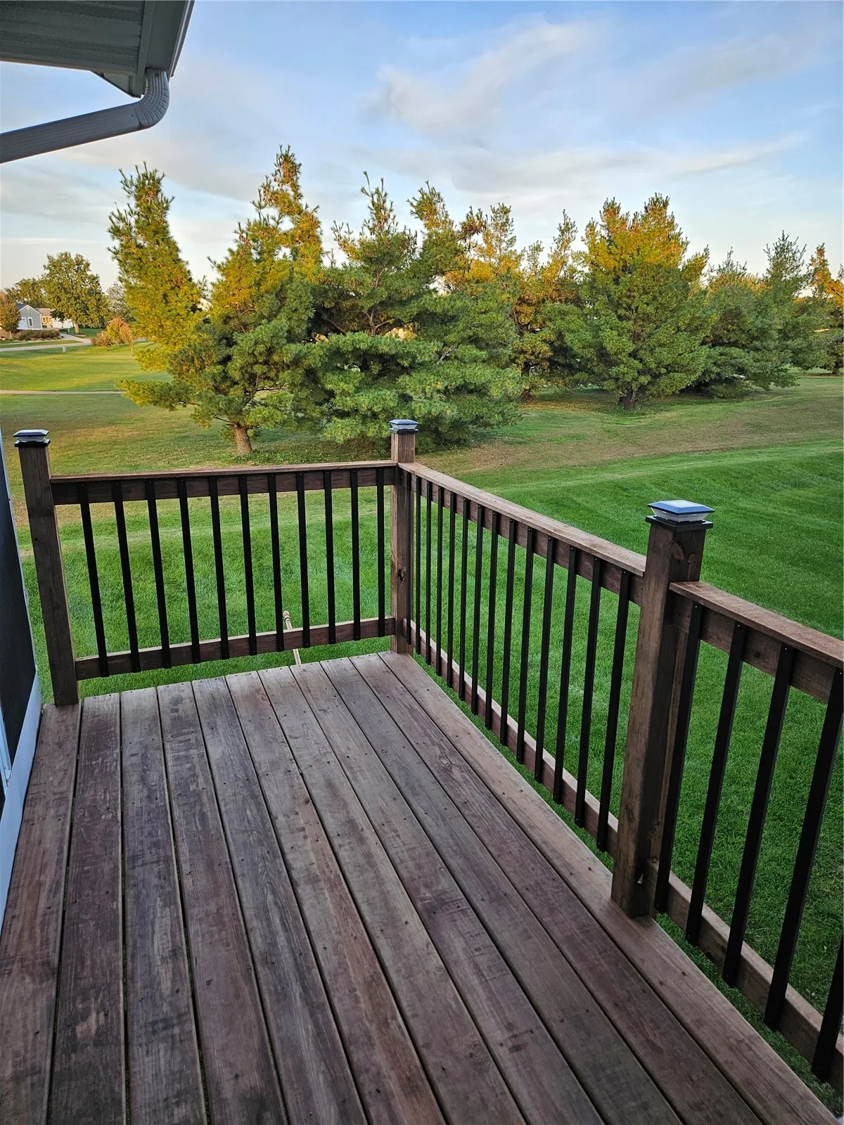 Updated deck with black iron spindles off the 3 season's room