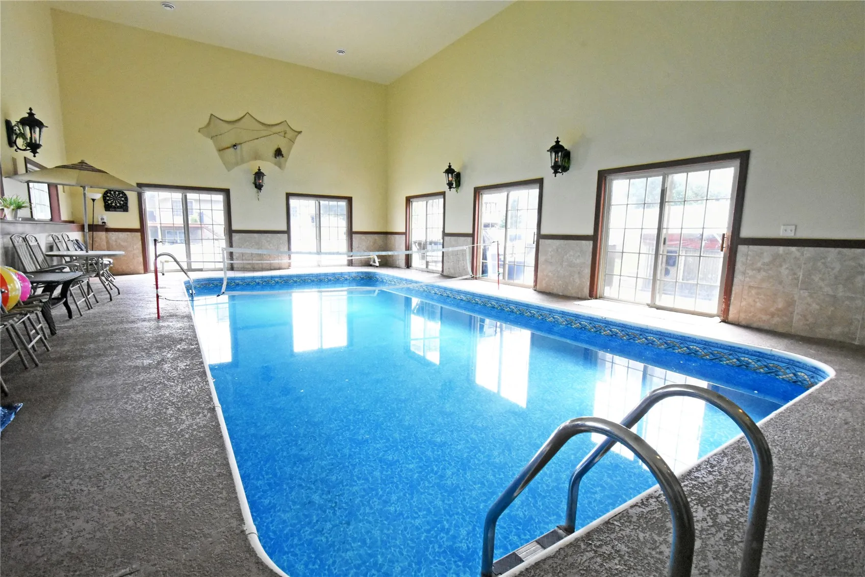 Pool room has 5 sliders w/ French door windows