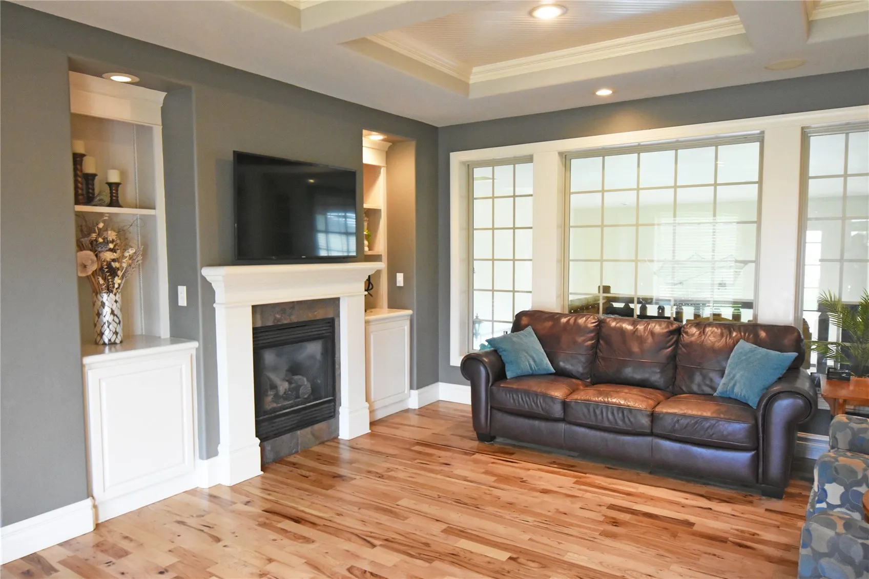Refinished hardwood floors and French windows overlooking pool room