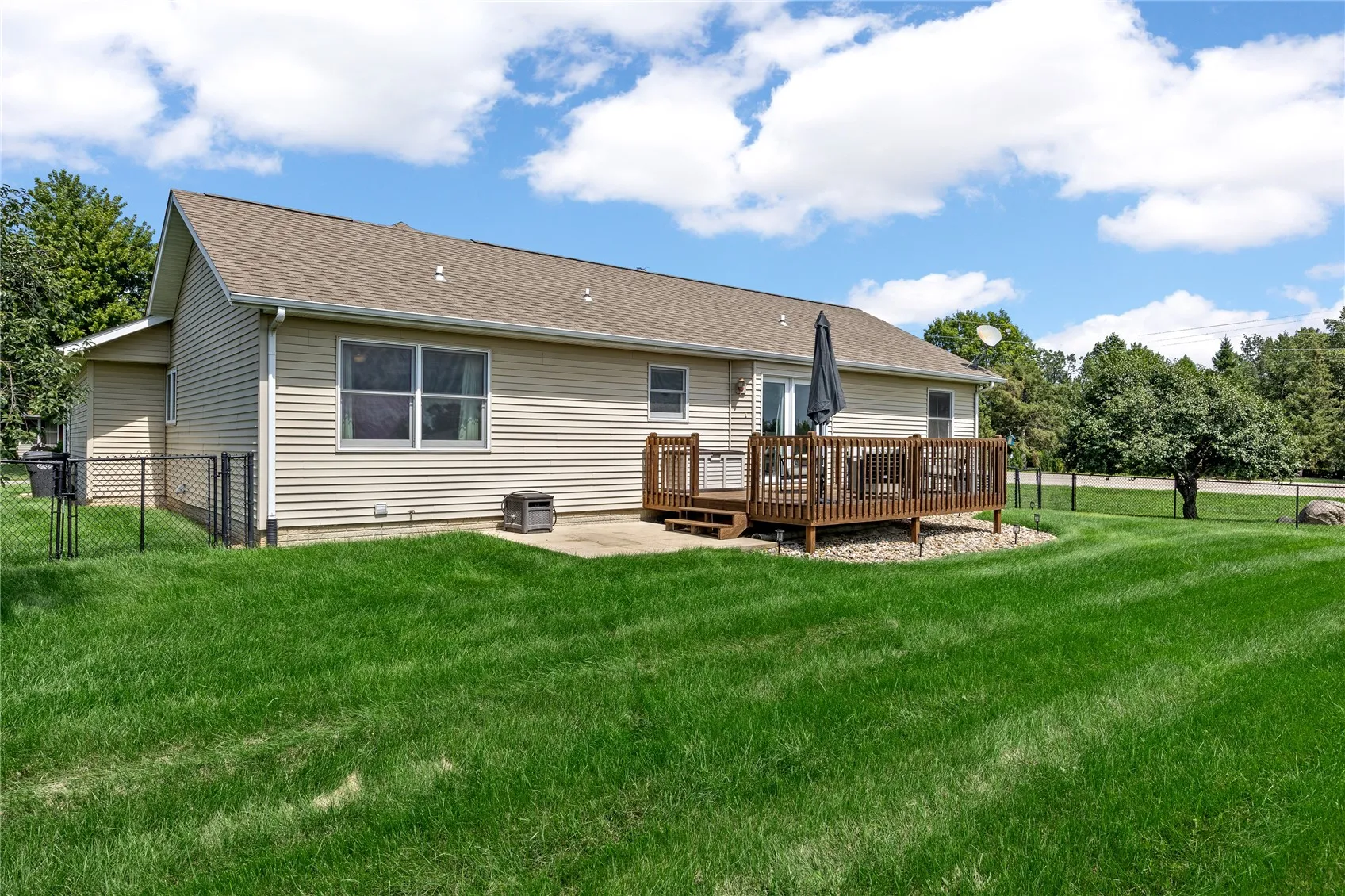 Good sized fenced in backyard with deck and patio.