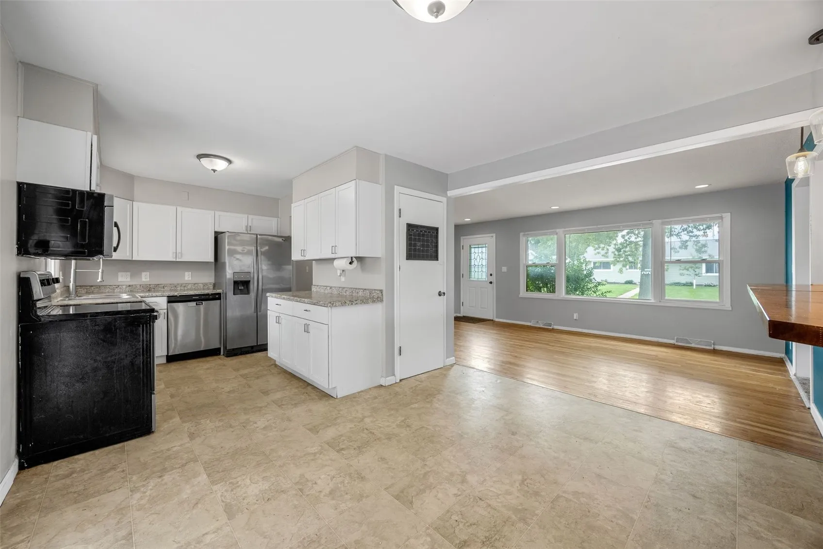 Dining area looking to living room and kitchen