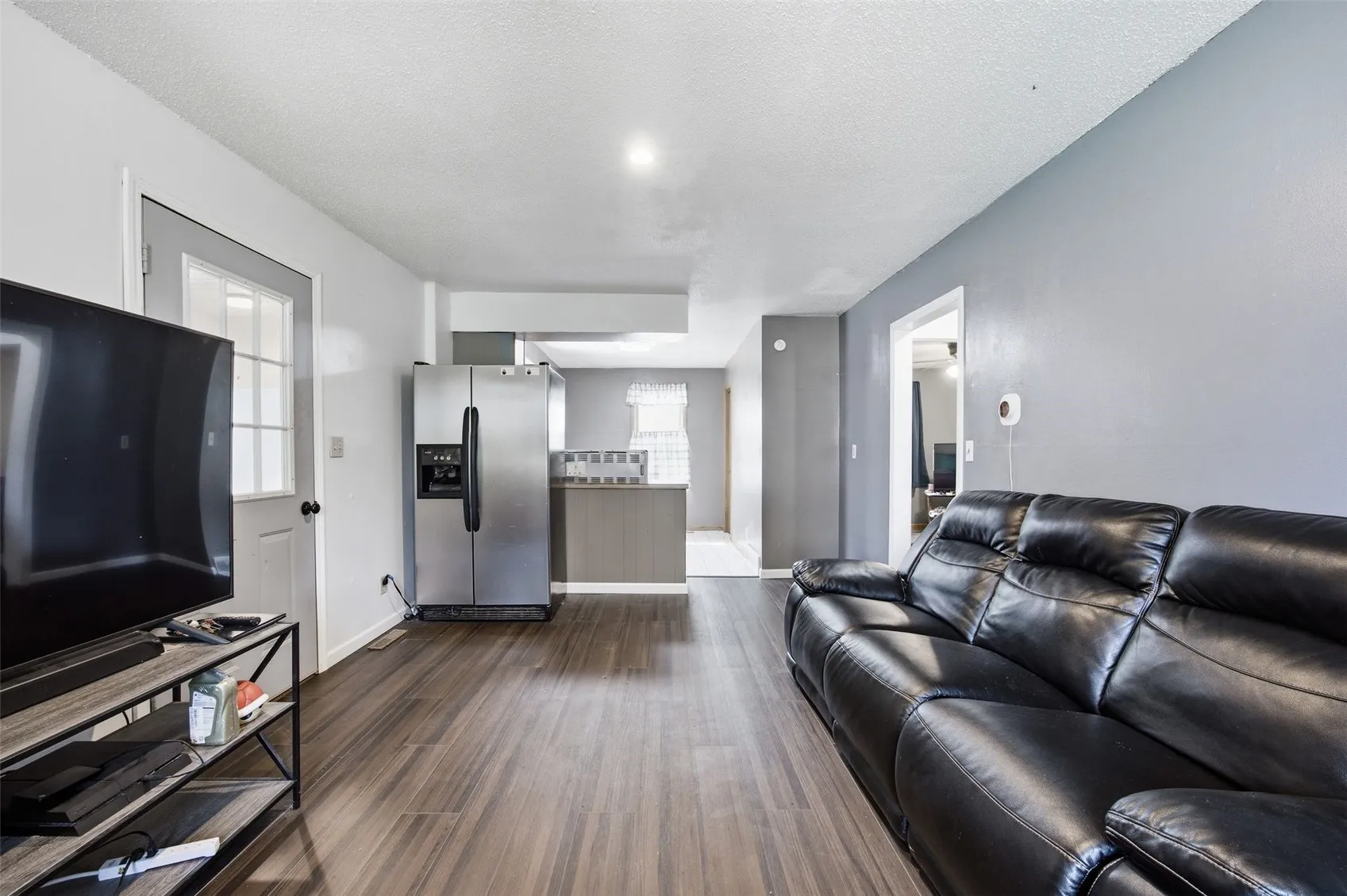 Main level unit living room looking to kitchen